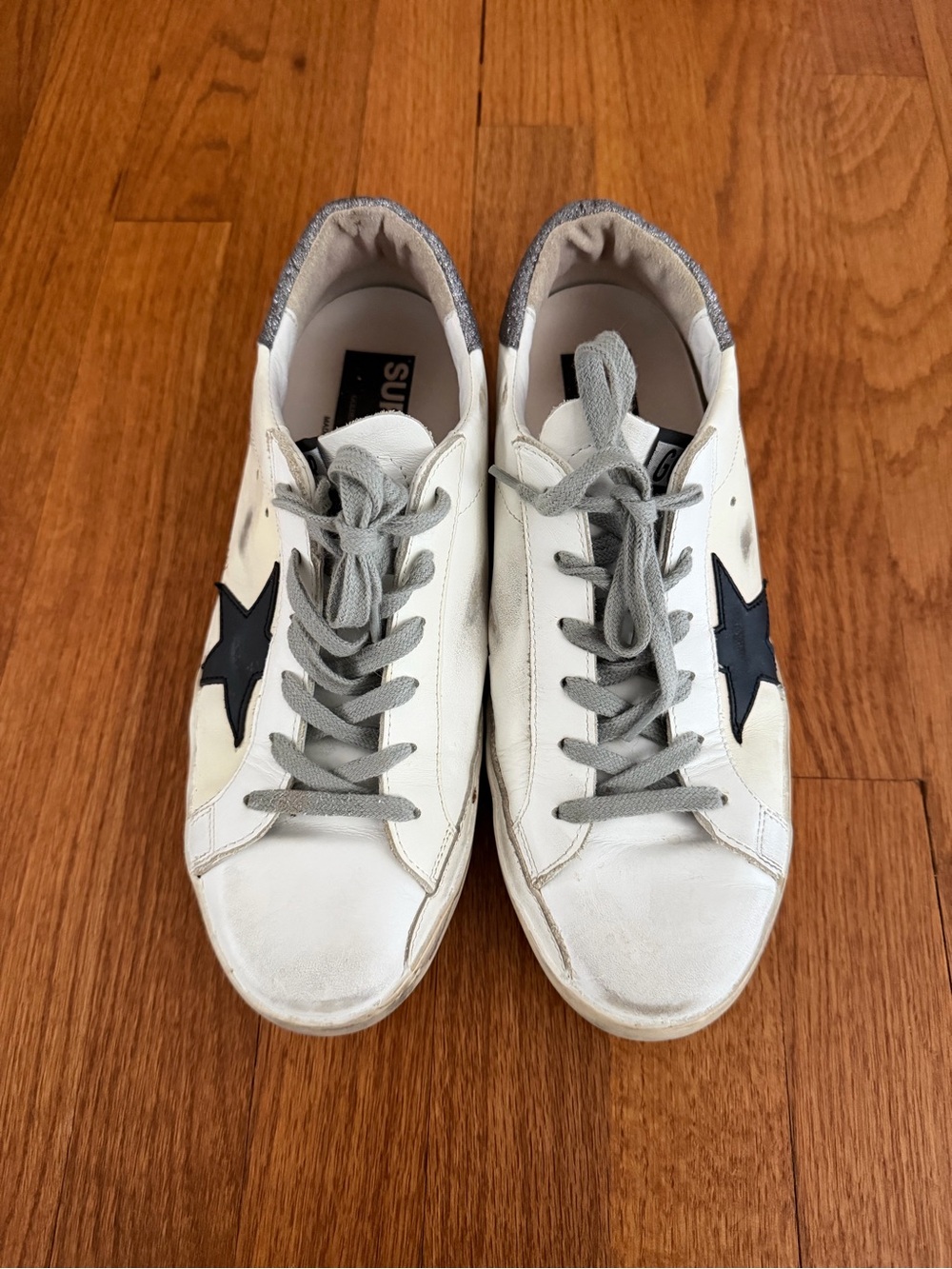 Golden Goose Superstar distressed white sneakers with black star